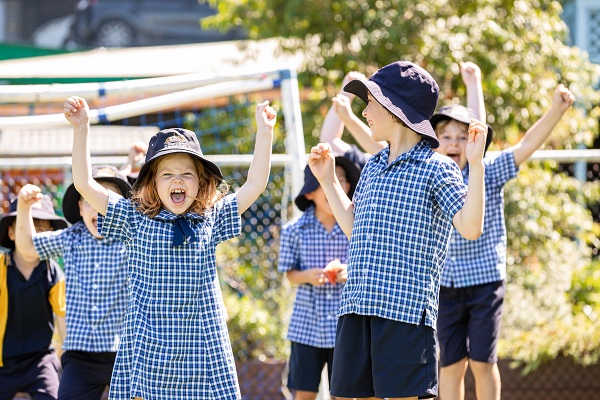 Students participating in an outdoor movement activity during school time.