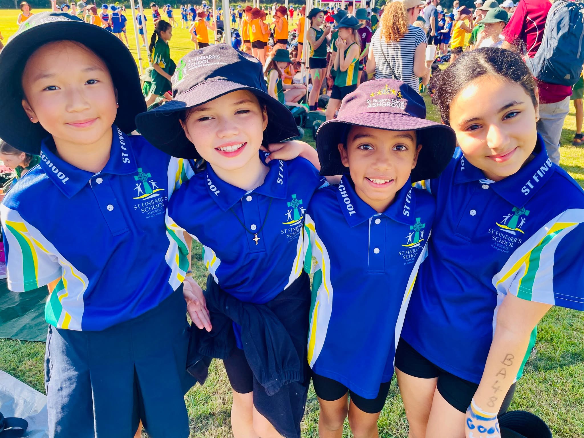 Students in school sports uniforms standing together at a school sports carnivaI.